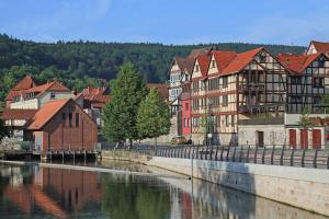 a group of buildings next to a river at Weserstein in Hannoversch Münden