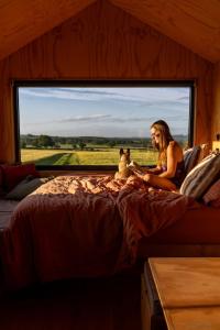 a woman sitting on a bed with a teddy bear at Sirius in Kelsall