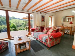 a living room with a couch and a table at Dan Castell Cottage in Llandeilo