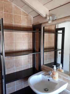 a bathroom with a sink and a mirror at Liopi Village Andros in Órmos