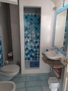 a bathroom with a toilet and a sink at La Coloniale San Pantaleo in San Pantaleo