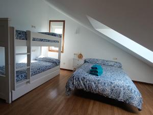 a bedroom with two bunk beds and a staircase at Apartamento Rio Gallo II in Cuntis