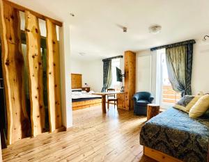 a bedroom with a bed and a desk in a room at Alpen Family Hotel Someda in Moena +85 photos