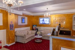 a living room with a couch and a table at Vila 18 Hotel Boutique in Bucharest