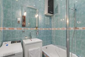 a bathroom with a toilet and a sink and a shower at Rynek Nowego Miasta 27 by NYX Apart in Skorka +13 photos
