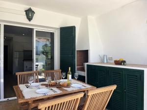 a dining table with a bottle of wine on it at COACH HOUSE by SOM Menorca in Son Parc