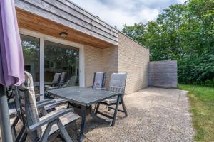 a table and chairs sitting on a patio at Hoogelandt 92 in De Koog +6 photos