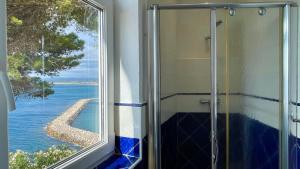 una ducha con ventana con vista al agua en Villa Narcol, en L'Estartit 56 fotos más