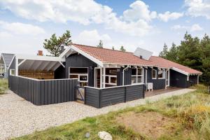 a black house with a red roof at 990-Thisted-Spanggardsvej-29 in Torsted
