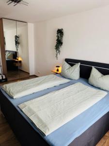 a bedroom with a large bed with blue sheets at Zentraler Moment in Chemnitz