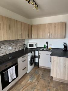 a kitchen with white appliances and wooden cabinets at Zentraler Moment in Chemnitz