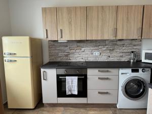a kitchen with a refrigerator and a dishwasher at Zentraler Moment in Chemnitz