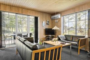 a living room with couches and a table and a television at 406-Vestervig-Bekkasinvej-6 in Vestervig