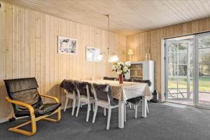 a dining room with a table and chairs at 406-Vestervig-Bekkasinvej-6 in Vestervig