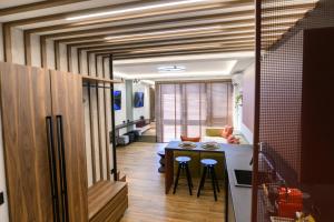 a living room with a table and a couch at Flo Flat in Alexandroupoli