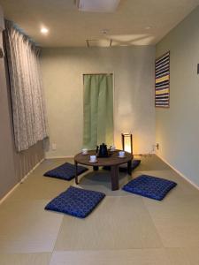 a room with a table and four blue mats at CS Asakusa Building 2nd floor - Vacation STAY 95354v in Tokyo