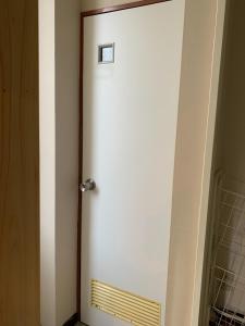 a white door with a sign on top of it at CS Asakusa Building 2nd floor - Vacation STAY 95354v in Tokyo +17 photos