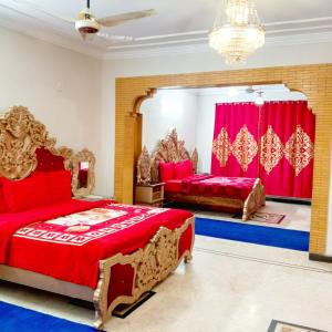 a bedroom with two beds and a large mirror at Hospitality Hub in Islamabad