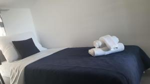 a bedroom with a bed with two towels on it at Innova TravelVir - Salt and Sun in Vir