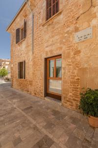 a brick building with a window and a sign on it at Petit Palau Alcudia - Adults Only in Alcudia