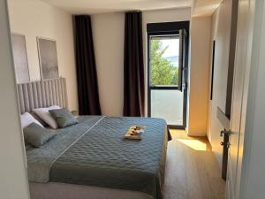 a bedroom with a bed and a large window at POLAI Seafront Apartment in Seline