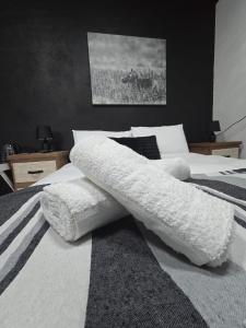 a bedroom with two beds with white pillows at Moo Manor Flat 1 in Kimberley
