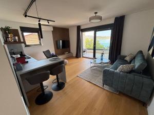 a living room with a desk and a couch at POLAI Seafront Apartment in Seline