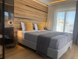 a bedroom with a large bed with a wooden headboard at INCORSΟ - Smart Luxury Stay - Athens Airport - PassCode Late Check In in Markopoulo