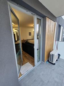 a room with a sliding glass door leading to a bedroom at LUXURY APARTMENTS WILCZA 8 by Marta klimatyzacja in Radom