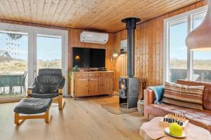 a living room with a couch and a stove at 525-Vestervig-Spovevej-5 in Vestervig