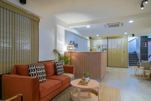 a living room with a couch and a table at Olive Zip Koramangala 4th Block by Embassy Group in Bengaluru