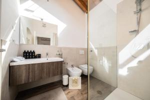 a bathroom with a sink and a toilet and a shower at GoldenSuitesItaly I Trento Duomo Suite 1 in Trento +47 photos