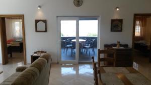 a living room with a couch and a table at Apartman Monte Cristo 500m do plaže-beach in Maslenica +21 photos