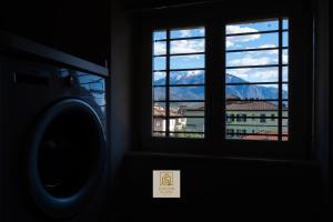 a window in a room with a view of a mountain at GoldenSuitesItaly I Trento Duomo Suite 1 in Trento