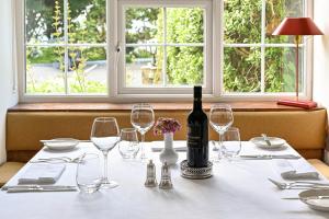 a table with a bottle of wine and glasses at Renvyle House Hotel & Resort in Renvyle