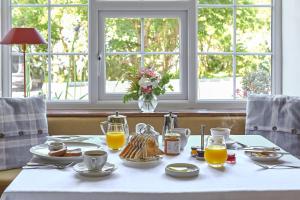 a table with breakfast foods and orange juice on it at Renvyle House Hotel & Resort in Renvyle