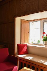 a window seat with a red pillow next to a window at Renvyle House Hotel & Resort in Renvyle