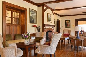 a living room with a couch and chairs and a fireplace at Renvyle House Hotel & Resort in Renvyle