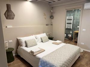 a bedroom with a bed with towels on it at Dimora Costanza in Lucca