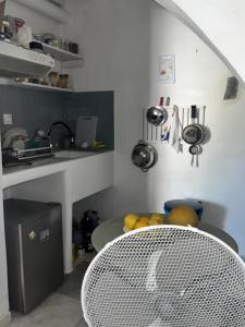 a kitchen with a sink and a table with a bowl of fruit at OrkiSEA-Orkos beach in Mikri Vigla +51 photos