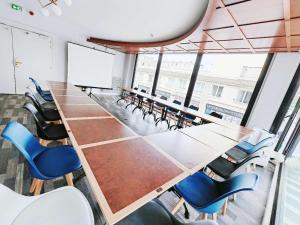 a conference room with a long table and chairs at ibis Styles Le Havre Centre in Le Havre