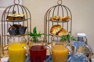 a table with three tiers of pastries and glasses of orange juice at Darwins Townhouse in Shrewsbury