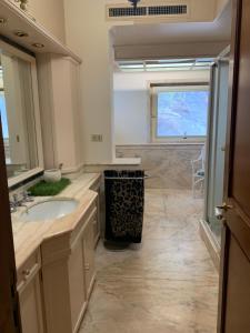 a large bathroom with a sink and a window at Park House in Mondello