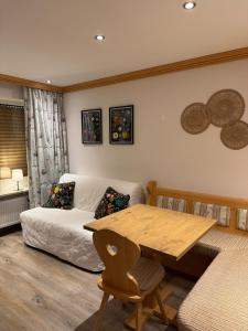 a living room with a table and a couch at Gemütliche Wohnung mit Bergblick und Terrasse in Obermaiselstein +18 photos