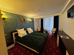a hotel room with a bed and a desk at Princess Butique in Poiana Brasov +88 photos