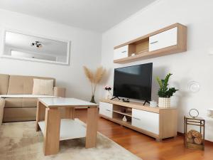 a living room with a television and a table at Apartman Dream in Livno