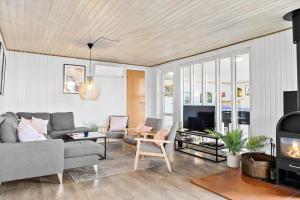 a living room with a couch and a fireplace at 905-Thisted-Kobbelsti-73 in Torsted