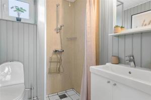 a bathroom with a shower and a toilet and a sink at 905-Thisted-Kobbelsti-73 in Torsted +21 photos