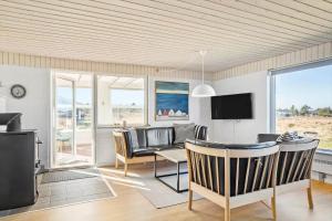 a living room with a table and chairs and a television at 132-Thisted-Sotungevej-31 in Thisted
