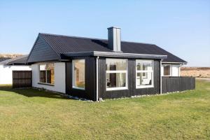 a black and white house with a grass yard at 132-Thisted-Sotungevej-31 in Thisted